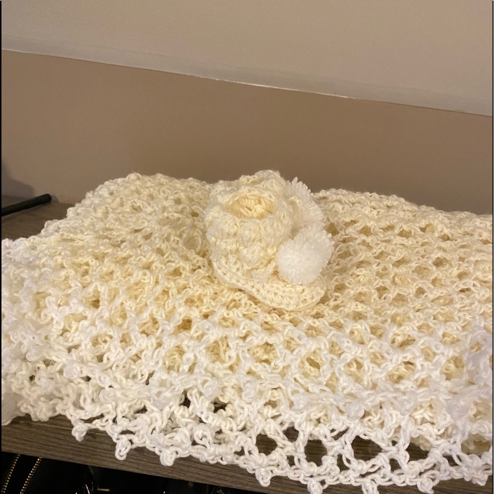 A hand crafted crochet baby Afghan and booties